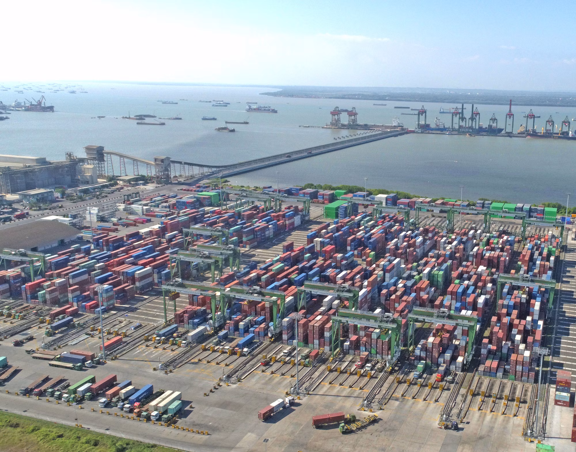 Aerial view of a busy shipping port with stacked containers